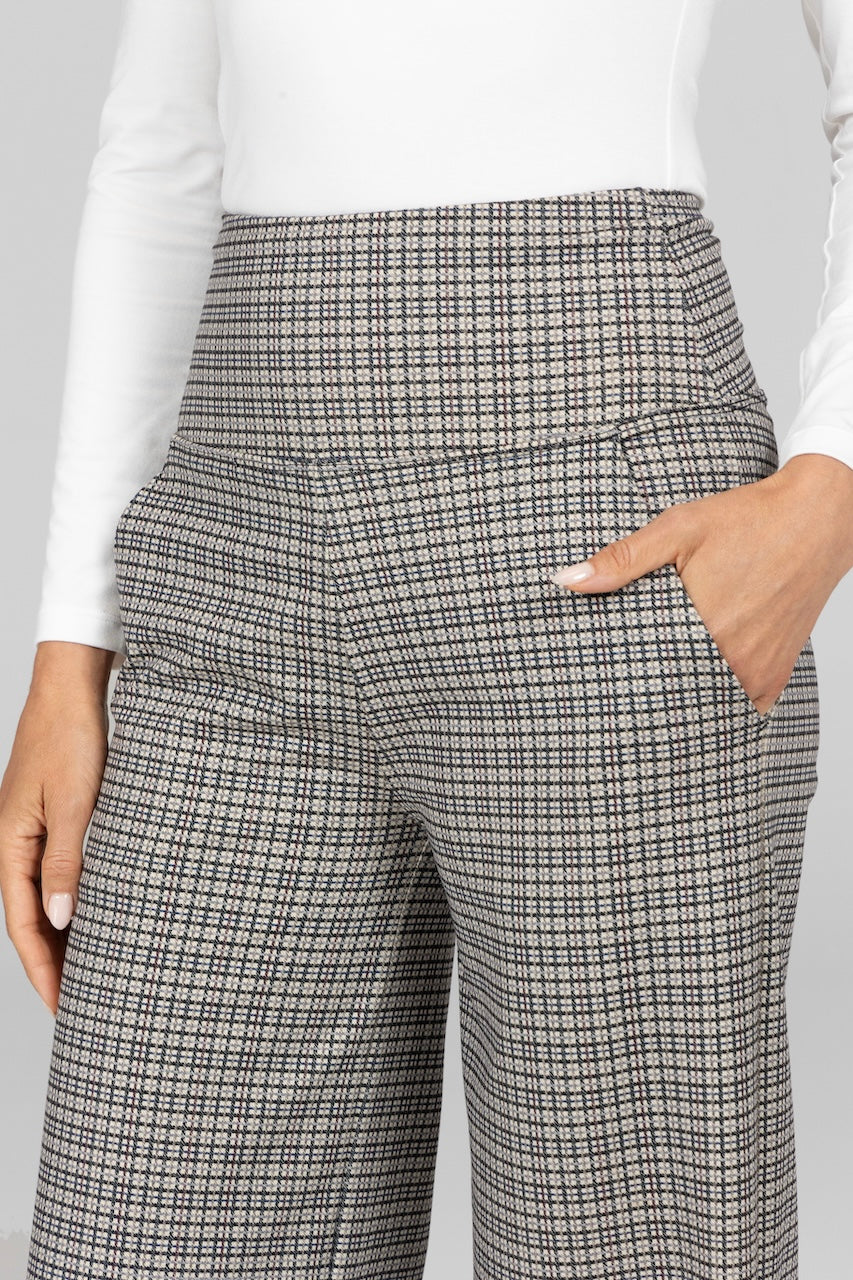 Close up of woman wearing high waisted pants with grey tattersall print