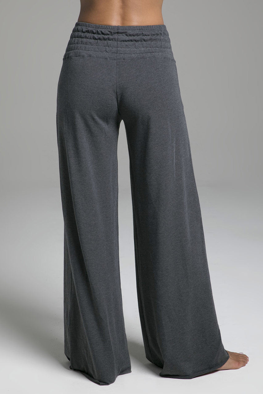 Back view of the KiraGrace Cozy Boho Yoga Pant in charcoal heather, highlighting the relaxed fit and draped silhouette