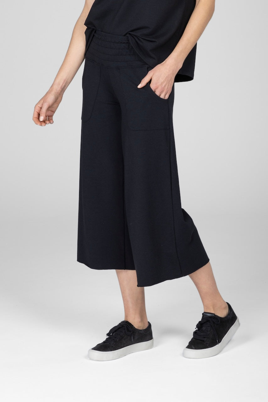 Woman wearing black cropped lounge pants