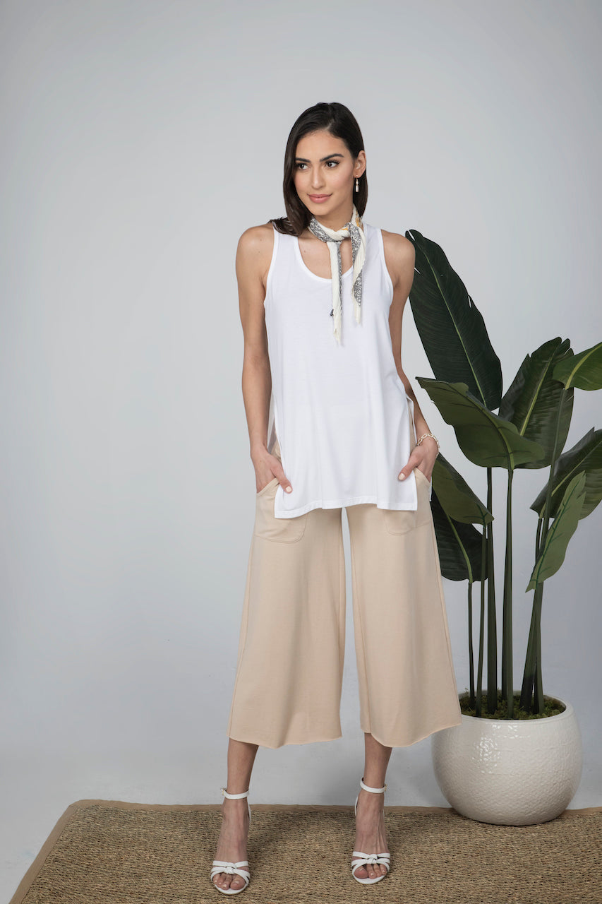 Model wearing a white shirt paired with the KiraGrace Cozy Boho Crop Yoga Pant in sand beige, showcasing a chic and relaxed outfit perfect for casual outings