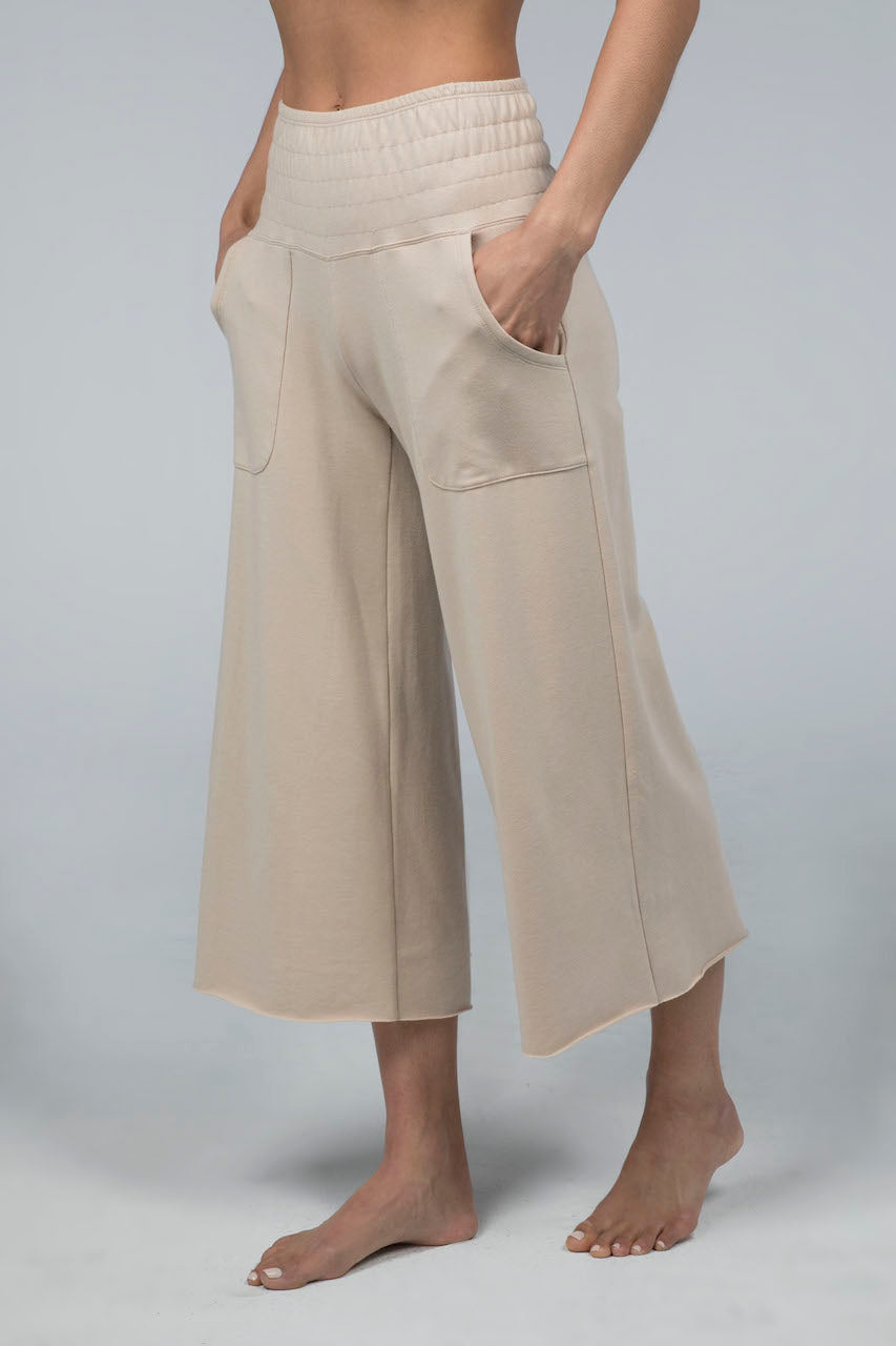 Side view of the KiraGrace Cozy Boho Crop Yoga Pant in sand beige, highlighting the relaxed fit and cropped length for a comfortable and stylish look