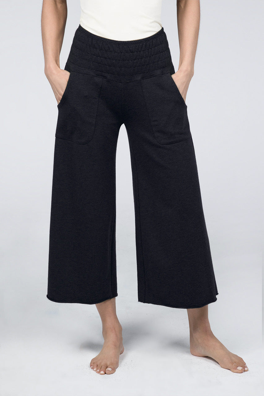 Woman wearing black cropped lounge pants with front pockets
