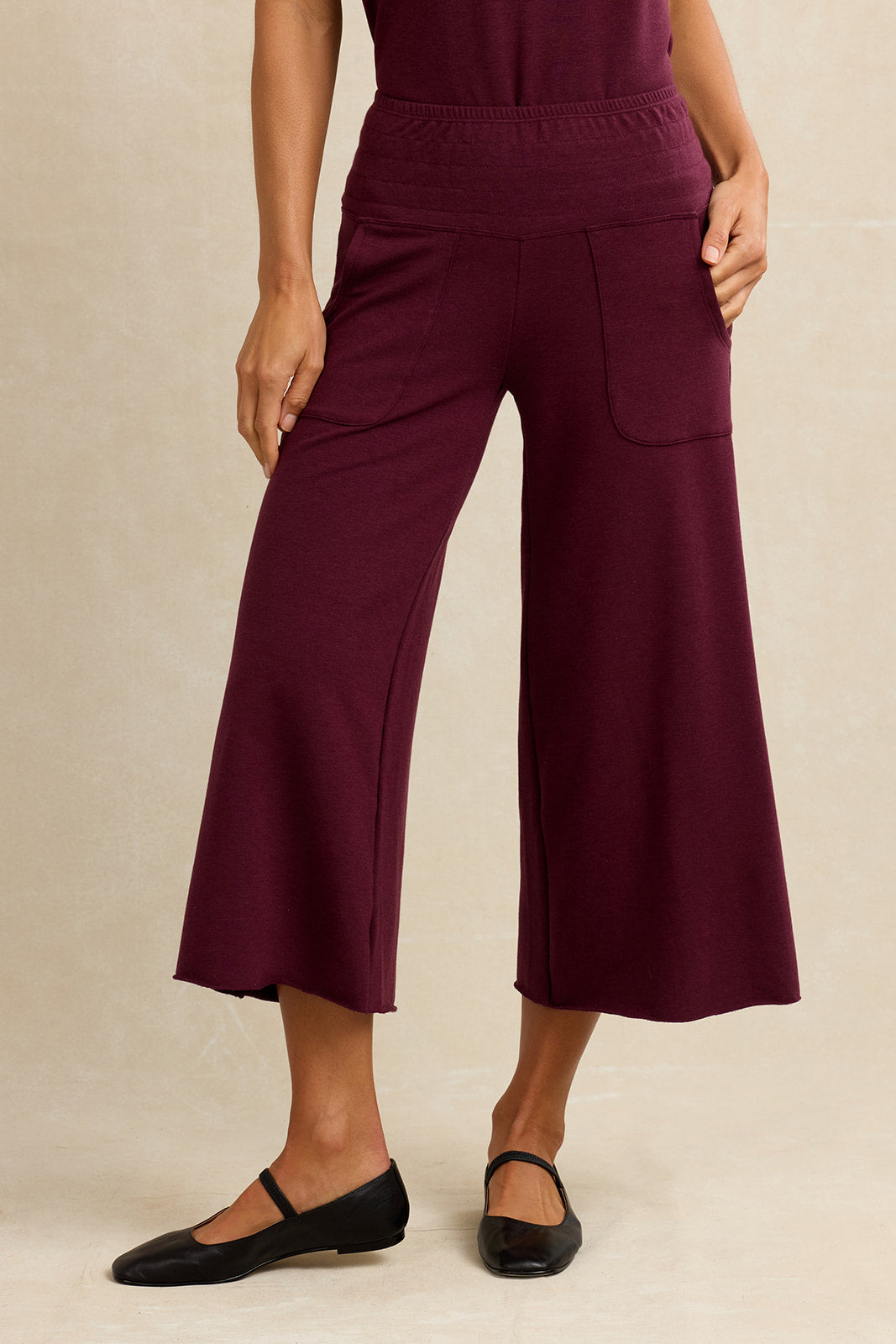 Woman wearing burgundy cropped lounge pants
