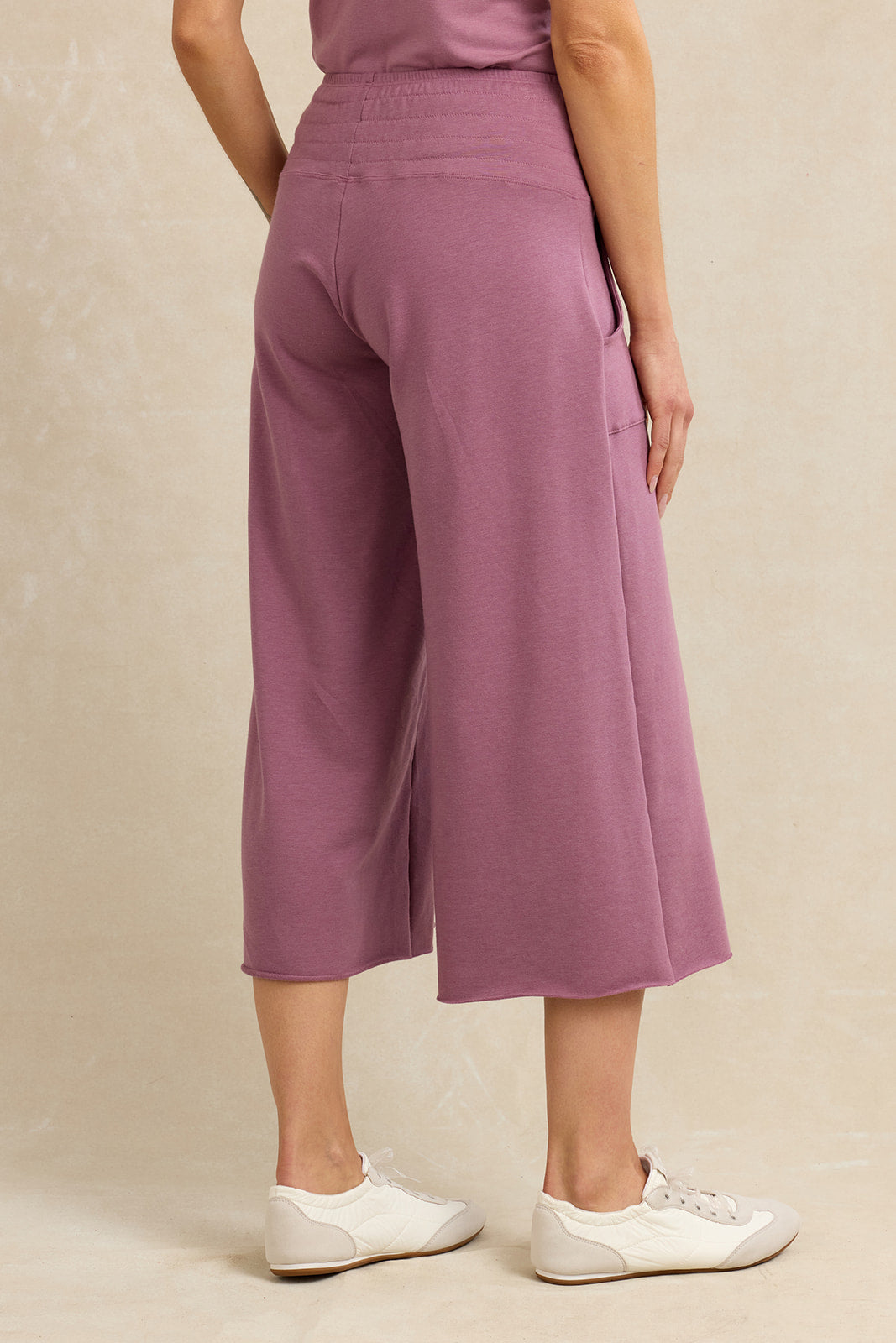 Back view of a woman wearing pink lounge cropped pants