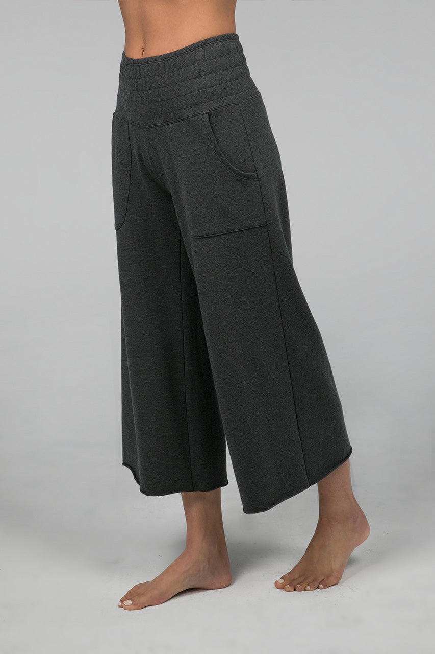 Side view of the KiraGrace Cozy Boho Crop Yoga Pant in charcoal heather, highlighting the cropped length and relaxed fit