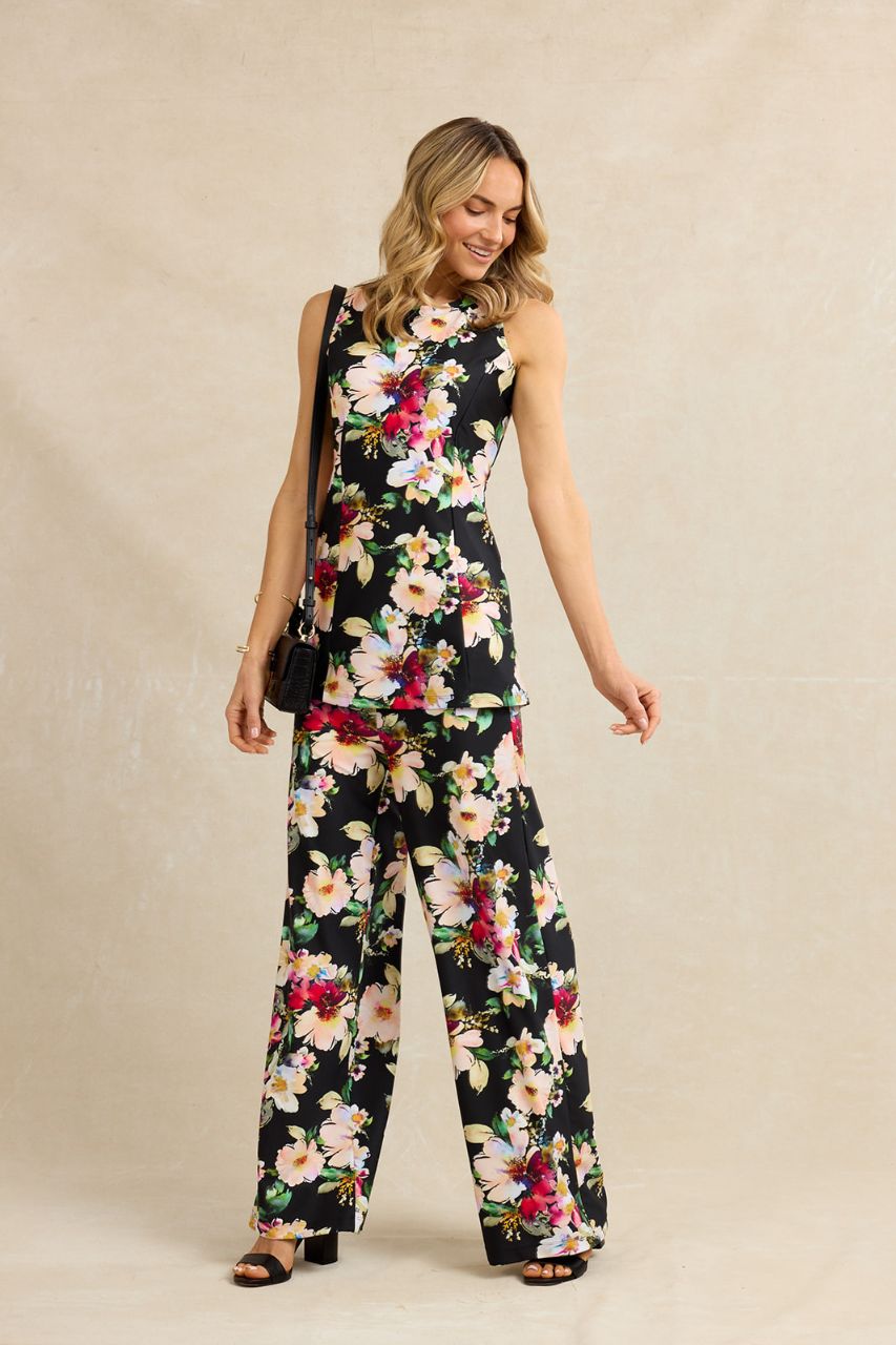 Woman wearing a floral outfit on a beige background