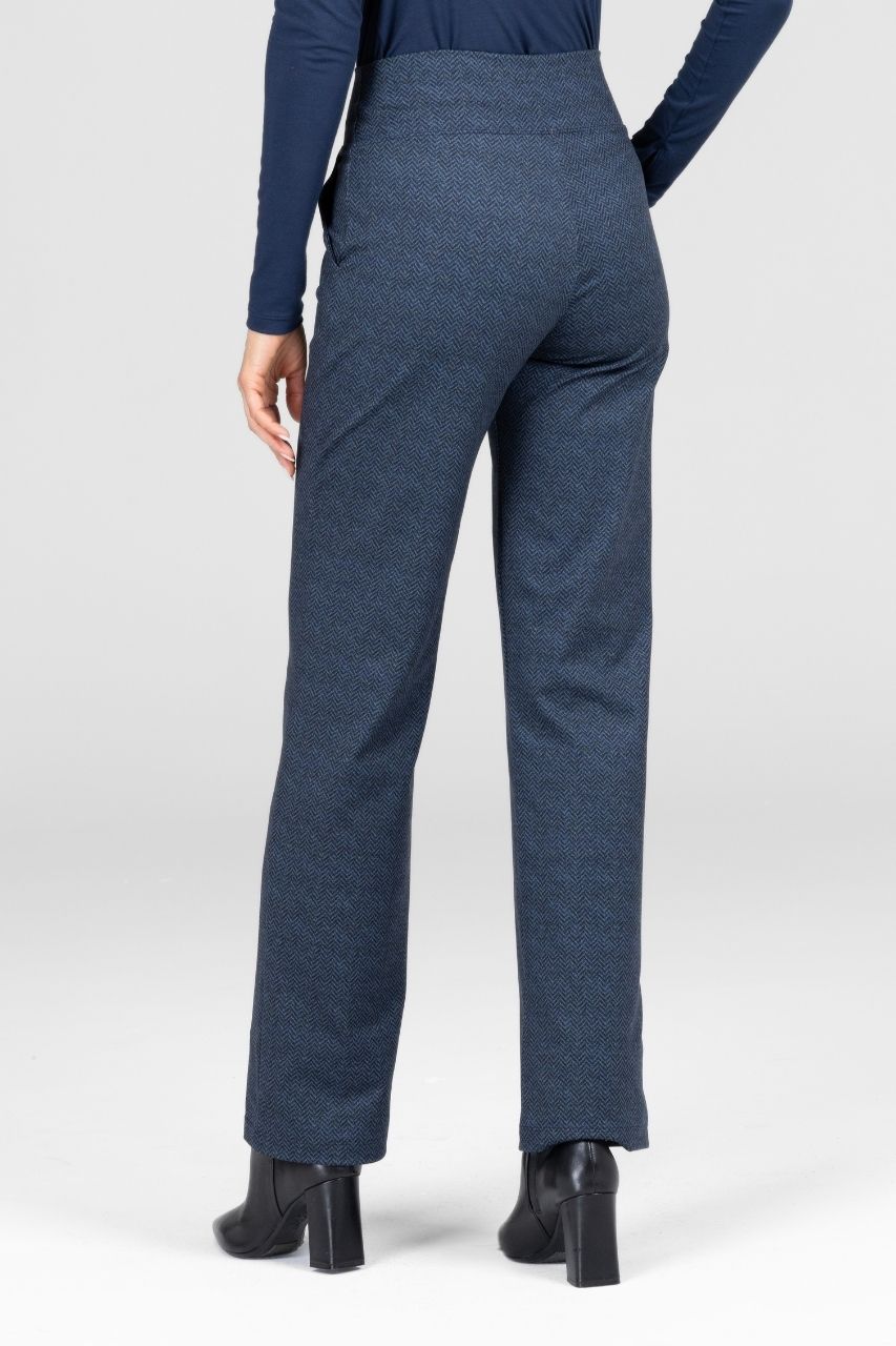 Back view of a woman wearing blue straight leg pants worn by a person on a white background