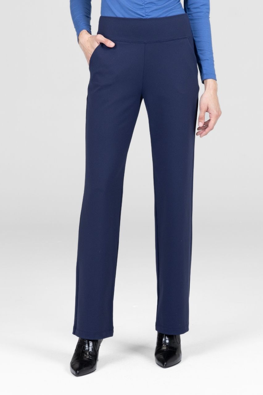 Woman wearing navy blue straight leg pants worn by a person on a white background