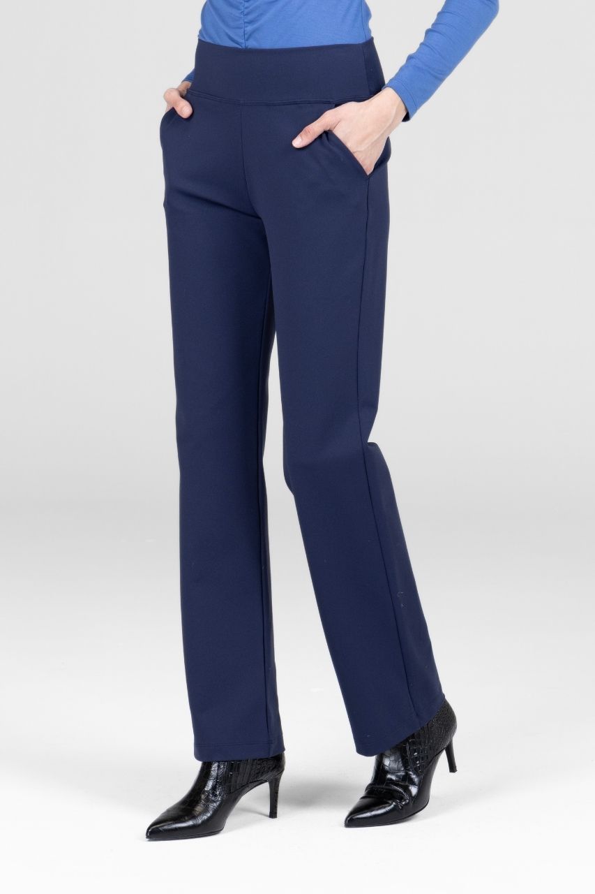 Woman wearing navy blue straight leg pants worn by a person on a white background