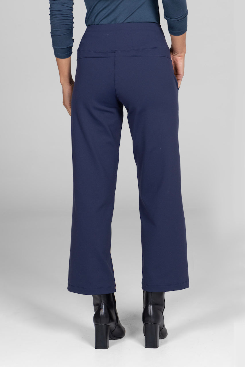 Back view of the Traveler Ankle Pant in marine navy, showcasing the flattering fit and elegant design from behind