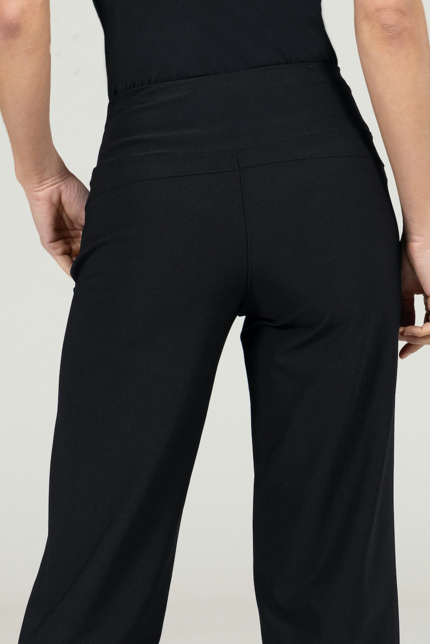 Close-up back view of the Traveler Ankle Pant in black, highlighting the tailored seams and smooth fabric texture