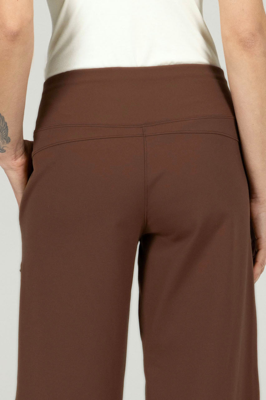 Close-up back view of the Traveler Ankle Pant in dark khaki, highlighting the smooth fabric and tailored seams for a refined look