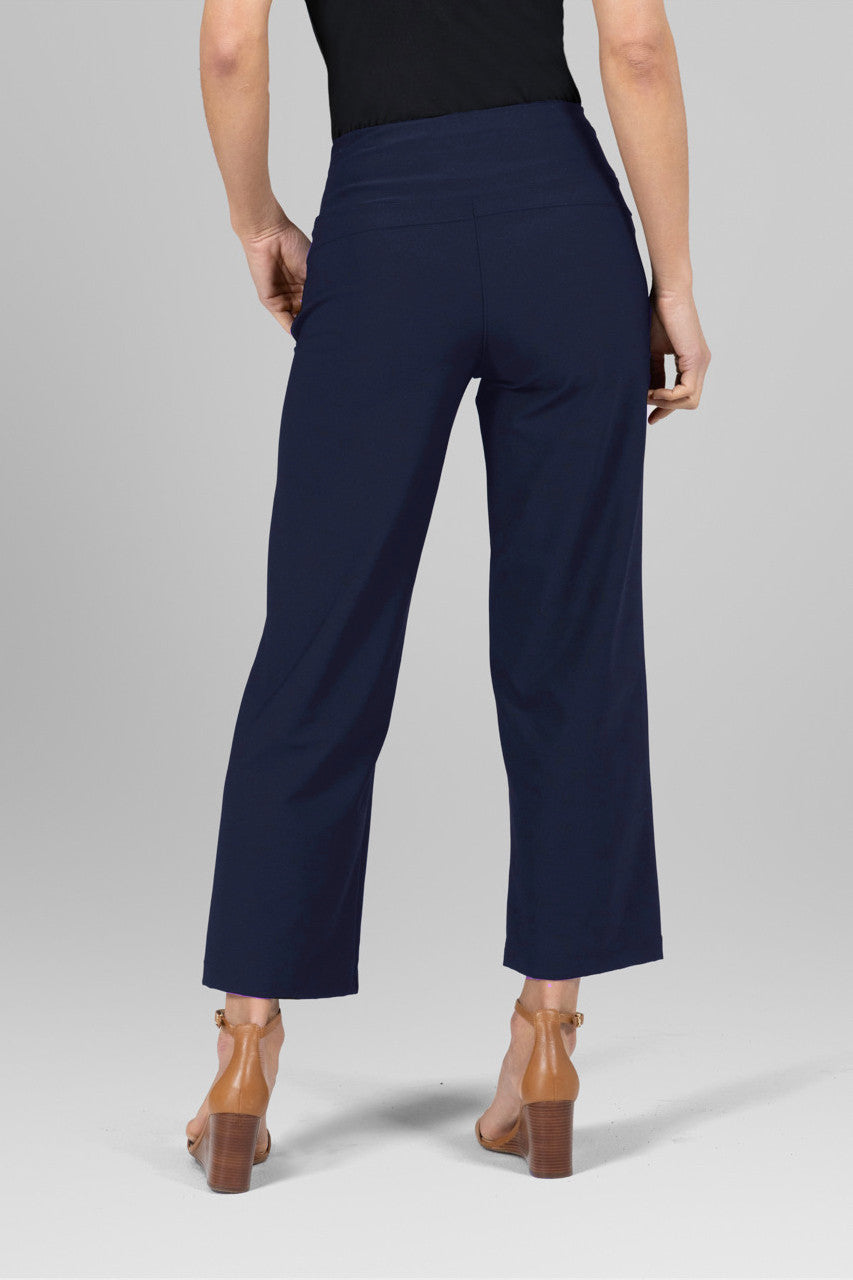 Back view of the Traveler Ankle Pant in marine navy, showcasing the flattering fit and elegant design from behind