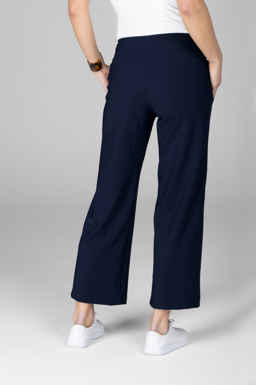 Back view of woman wearing marine navy ankle pants