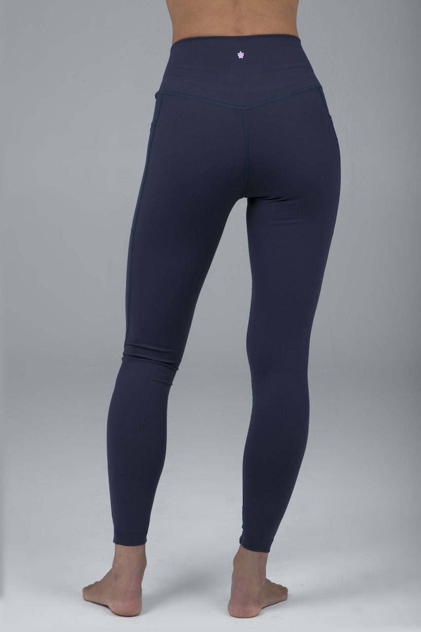 Back view of model wearing high waisted navy blue leggings