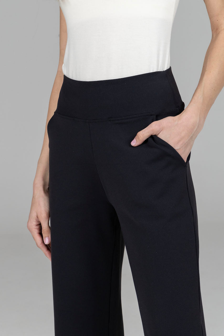 Close-up of the Nina Straight Leg Ankle Pant in black with a hand in the pocket, showcasing the fabric texture and stylish details of the pant."