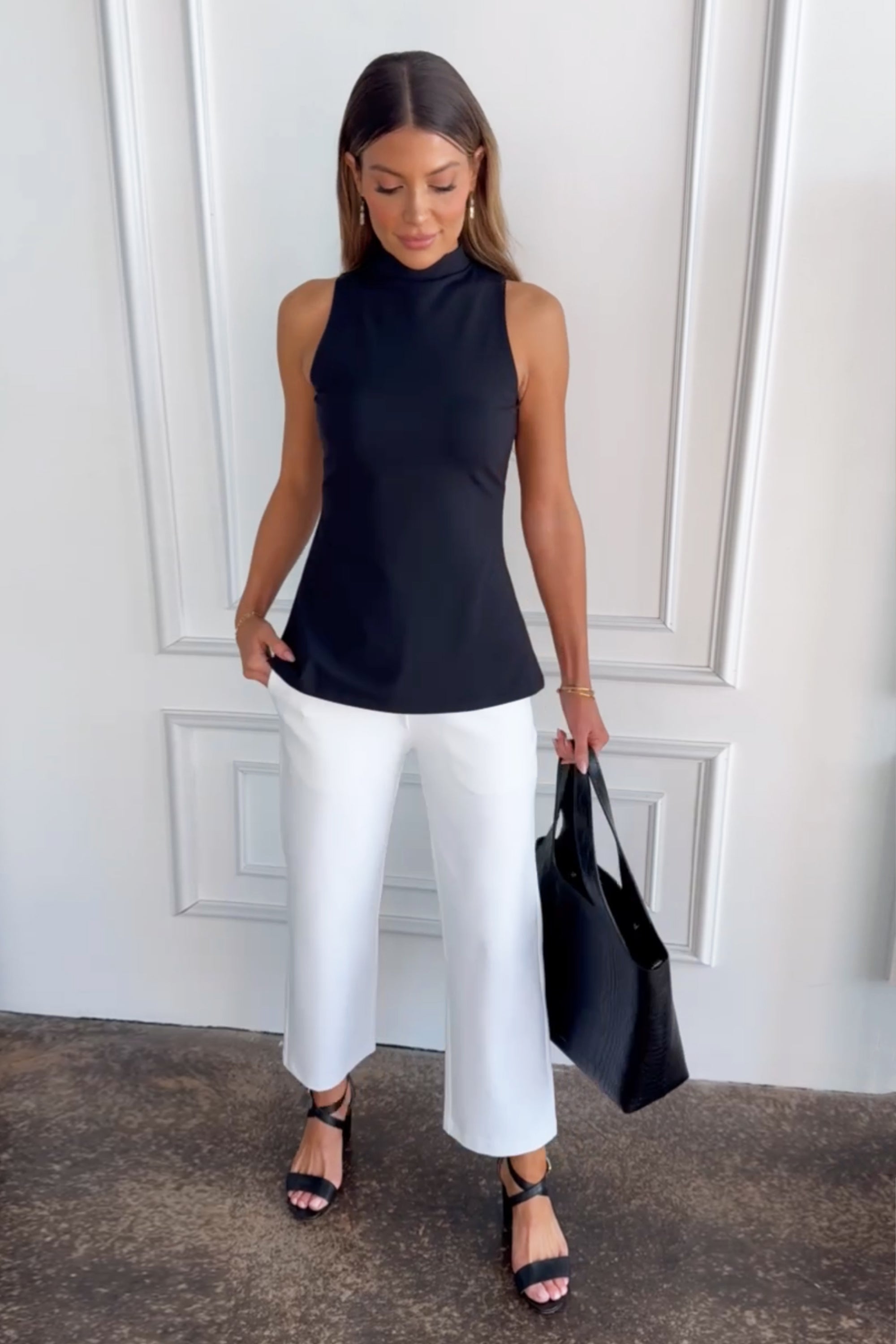 Women with a bag and black top in HIGH WAIST ANKLE PANT: WHITE