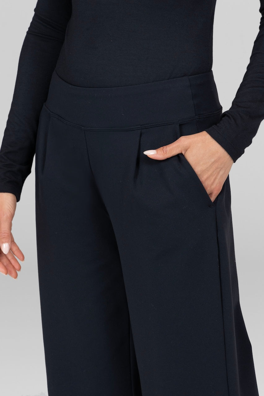 Close-up of the black Monica Pant, highlighting the fabric texture and clean lines of the design.