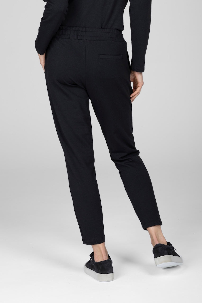 Back view of woman wearing black joggers