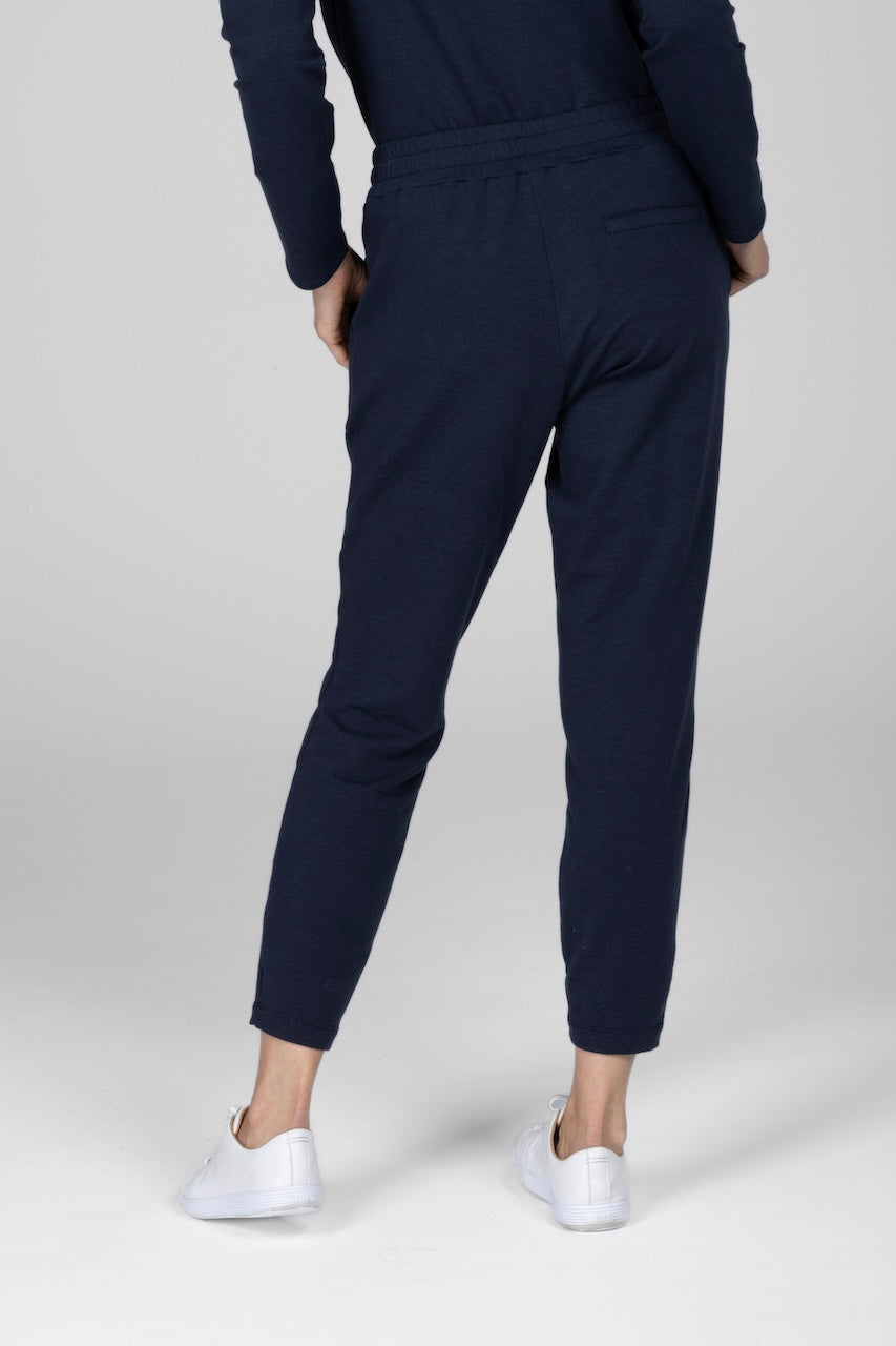 Back view of woman wearing navy joggers