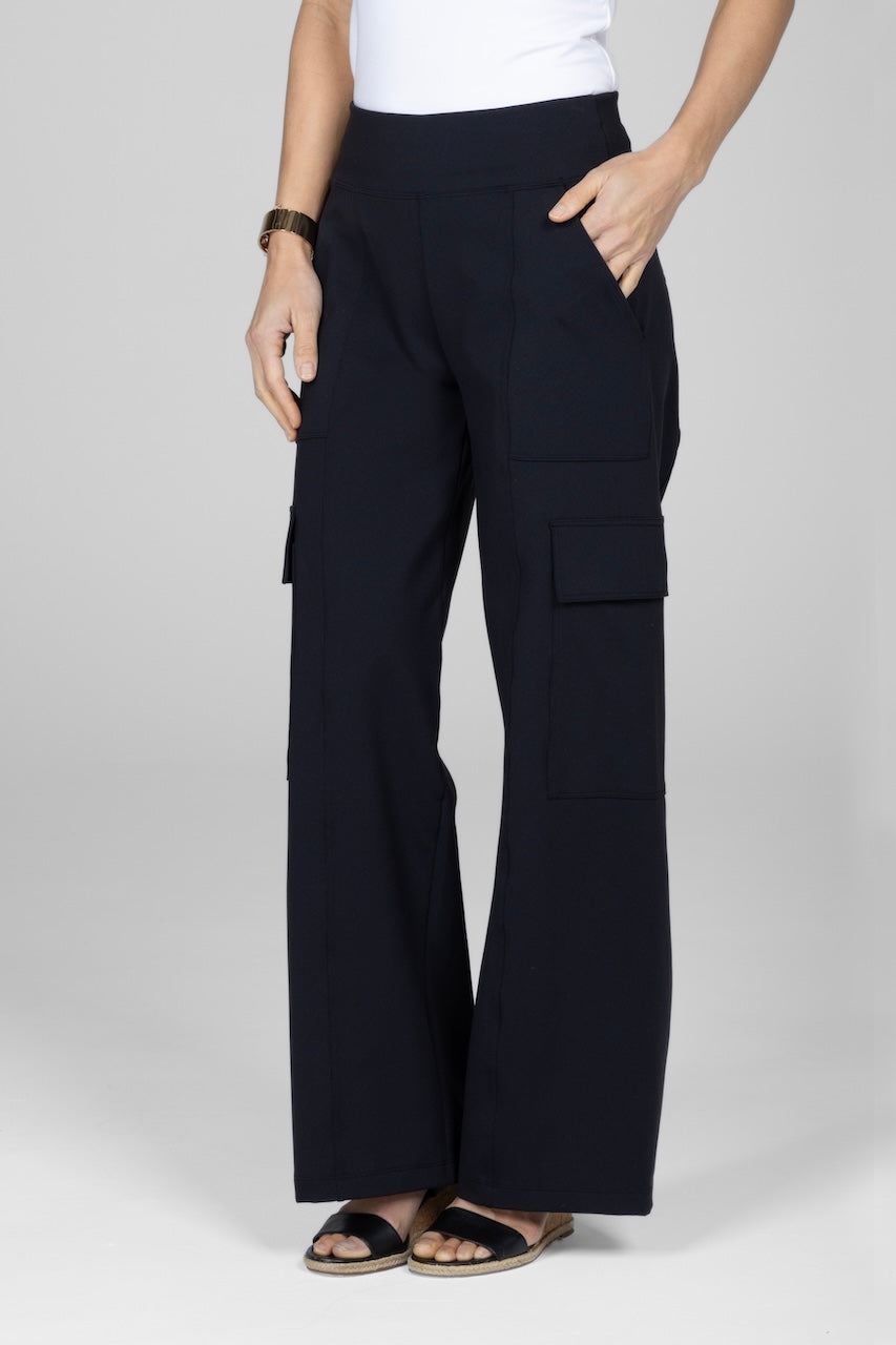 A model wearing black wide leg cargo pants with side pockets and hand in front pocket