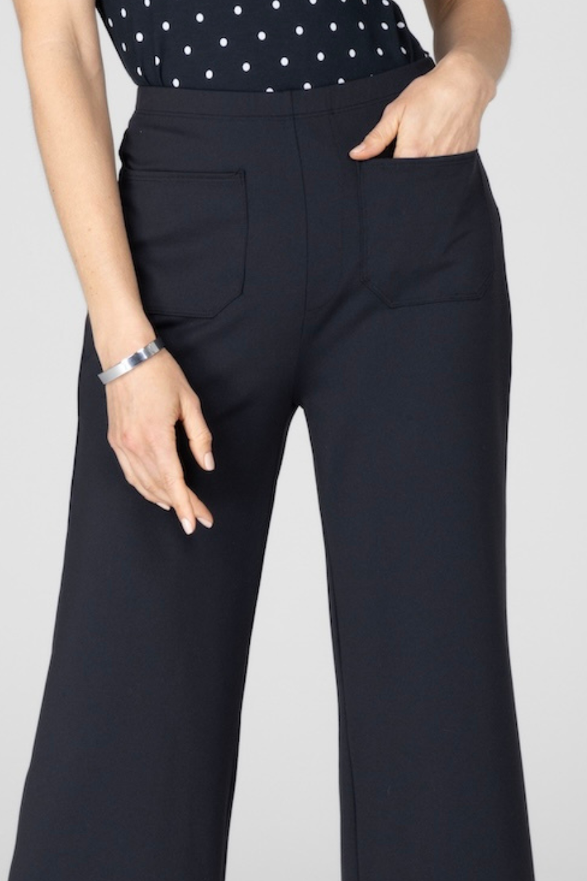 Close up of woman wearing black pants with front patch pockets
