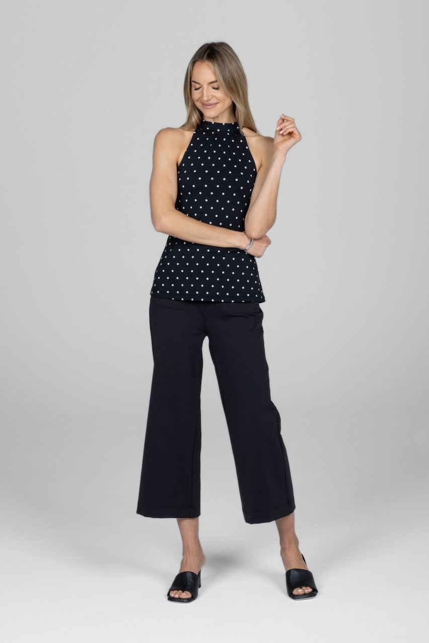 Woman wearing black dot halter top and black cropped pants