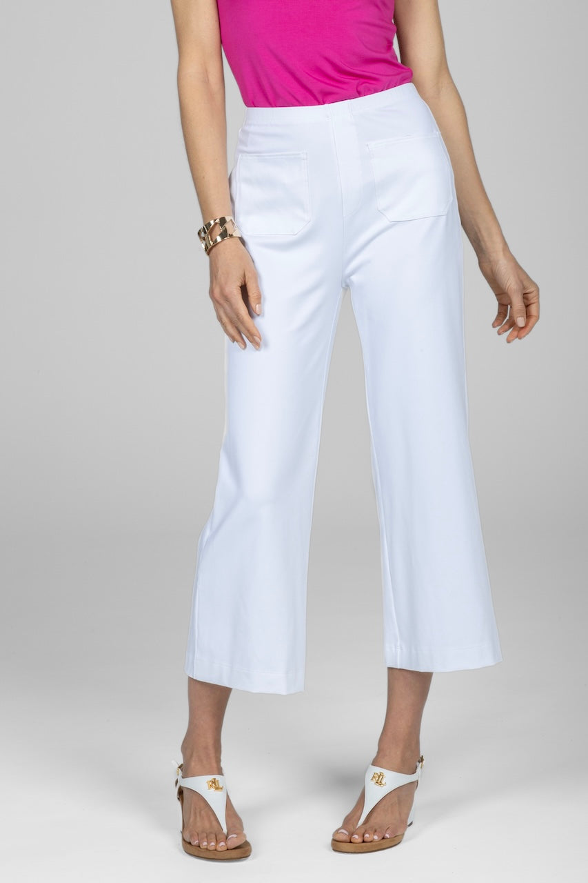A model wearing high-waisted white crop pants front patch pockets, paired with a pink top and white sandals.