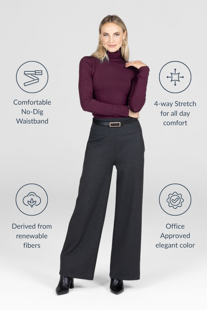 Woman wearing burgundy turtleneck and grey high waisted pants with pant attributes on the side