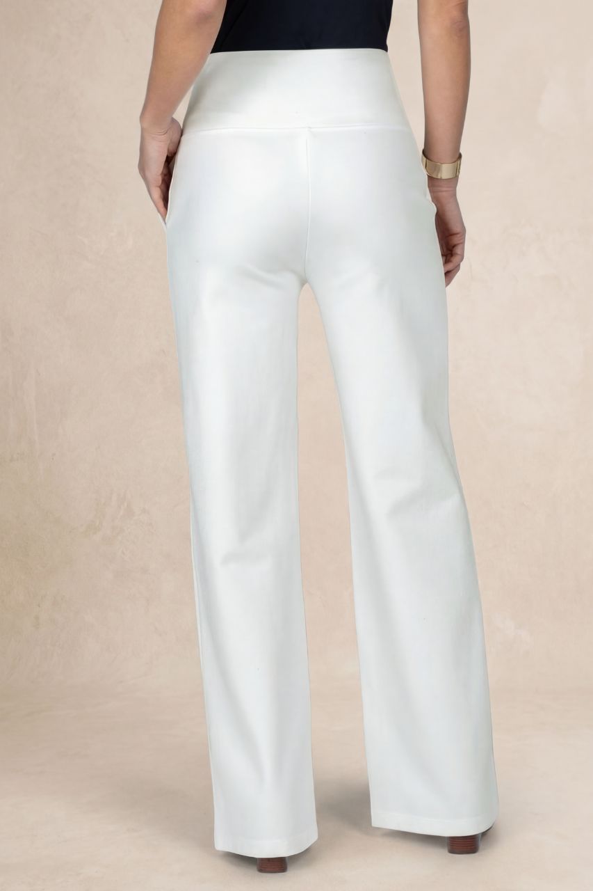 White pants worn by a person on a beige background