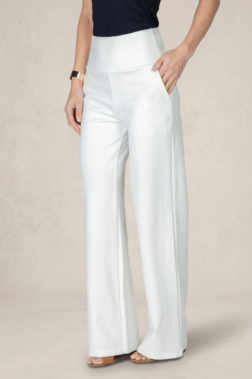 White wide-leg pants worn by a person on a beige background