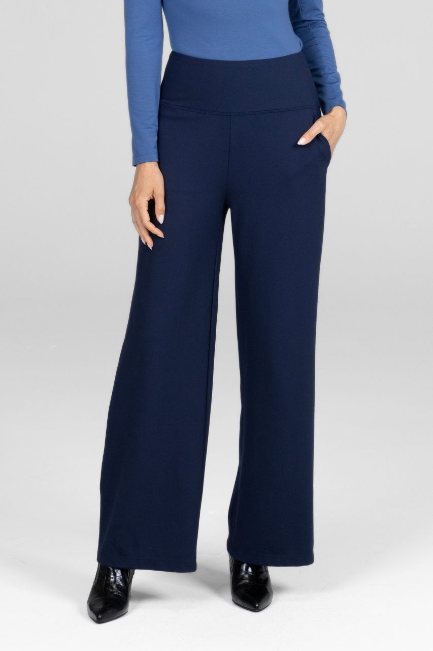 Navy blue wide-leg pants worn with a blue top on a white background