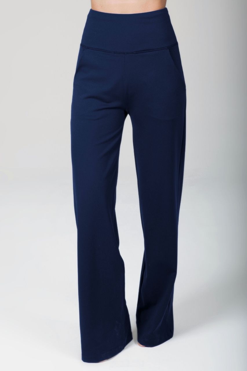 Woman wearing navy blue wide leg pants on a white background