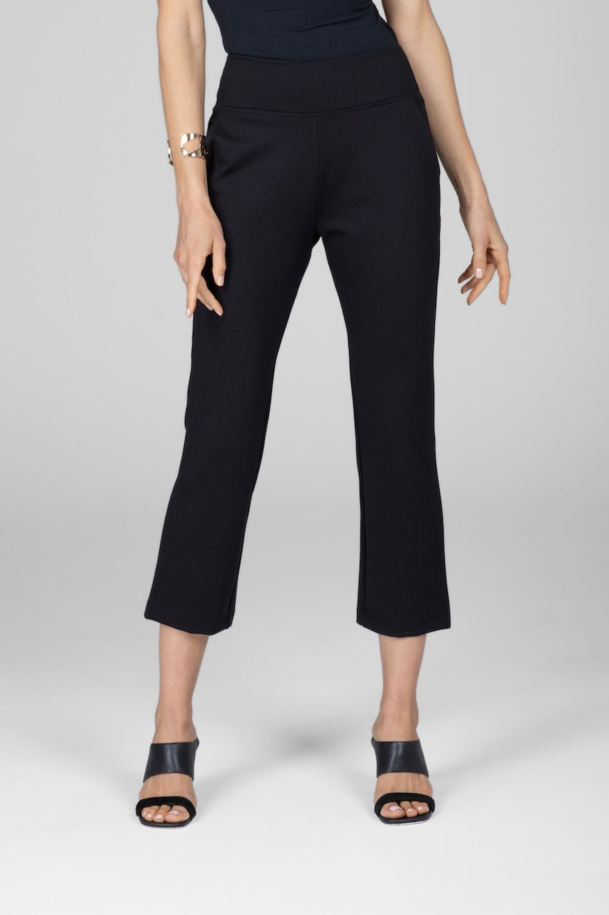 A model wearing high-waisted black ankle kick pants