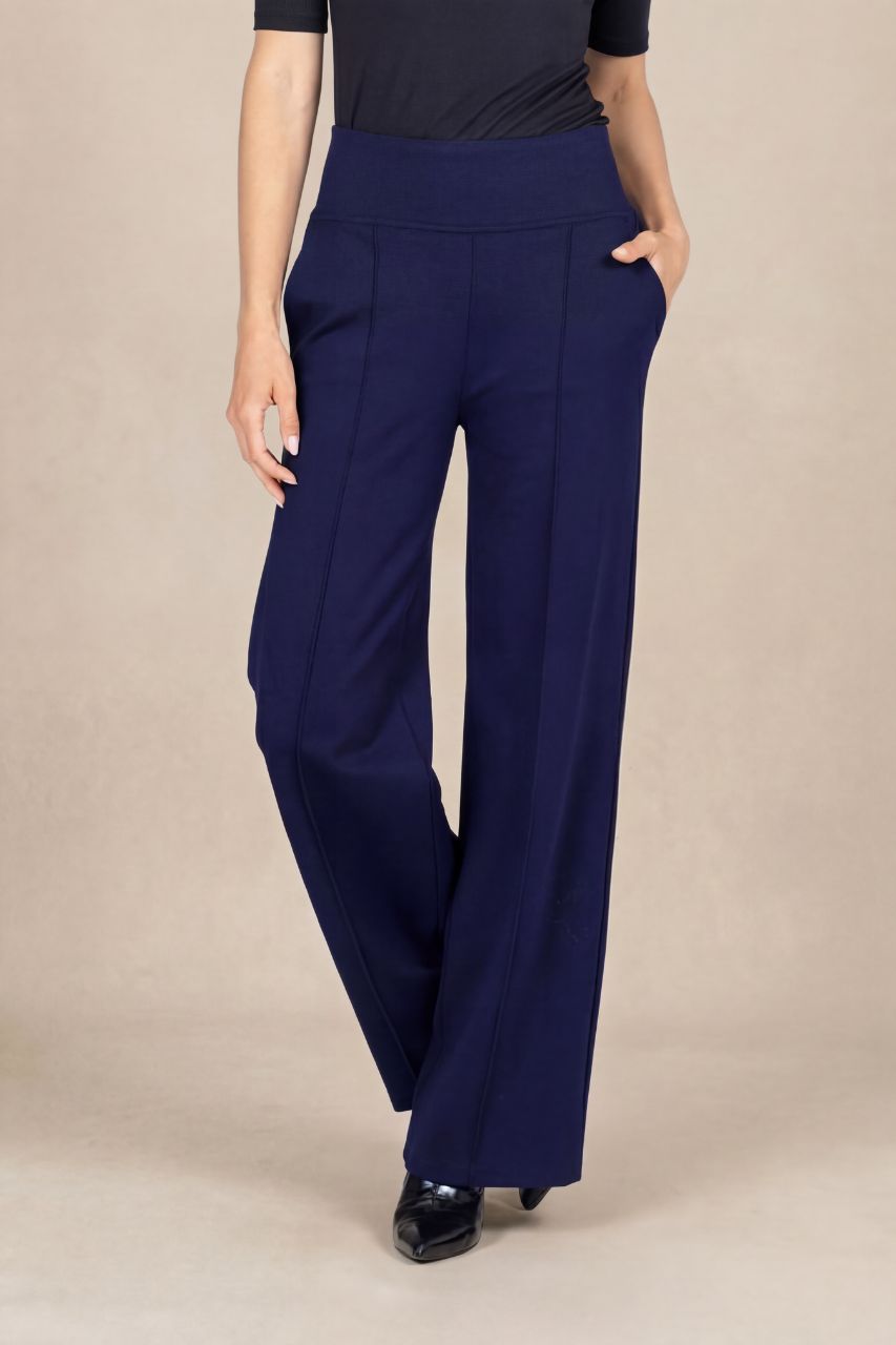 Navy blue wide-leg pants worn by a person on a beige background