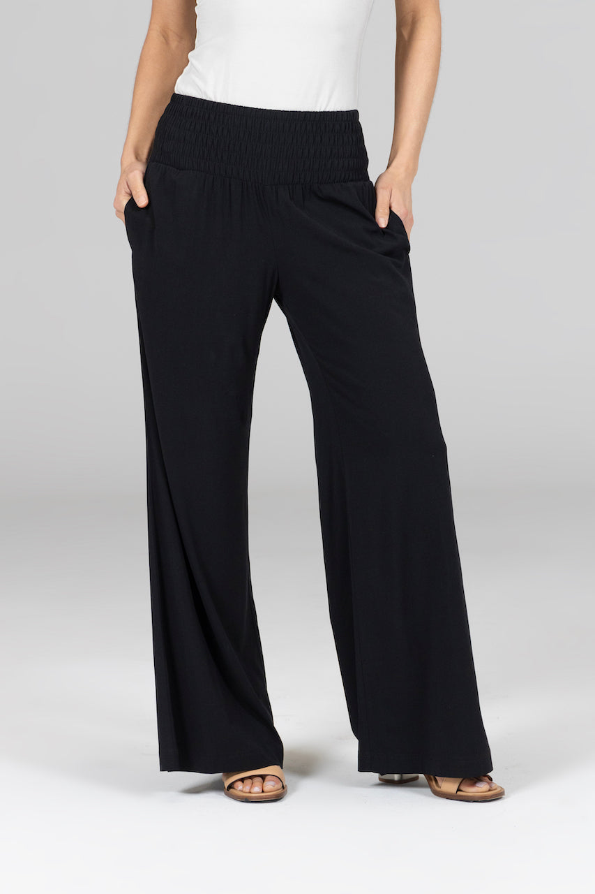 Woman wearing black high waisted wide leg pants with pockets