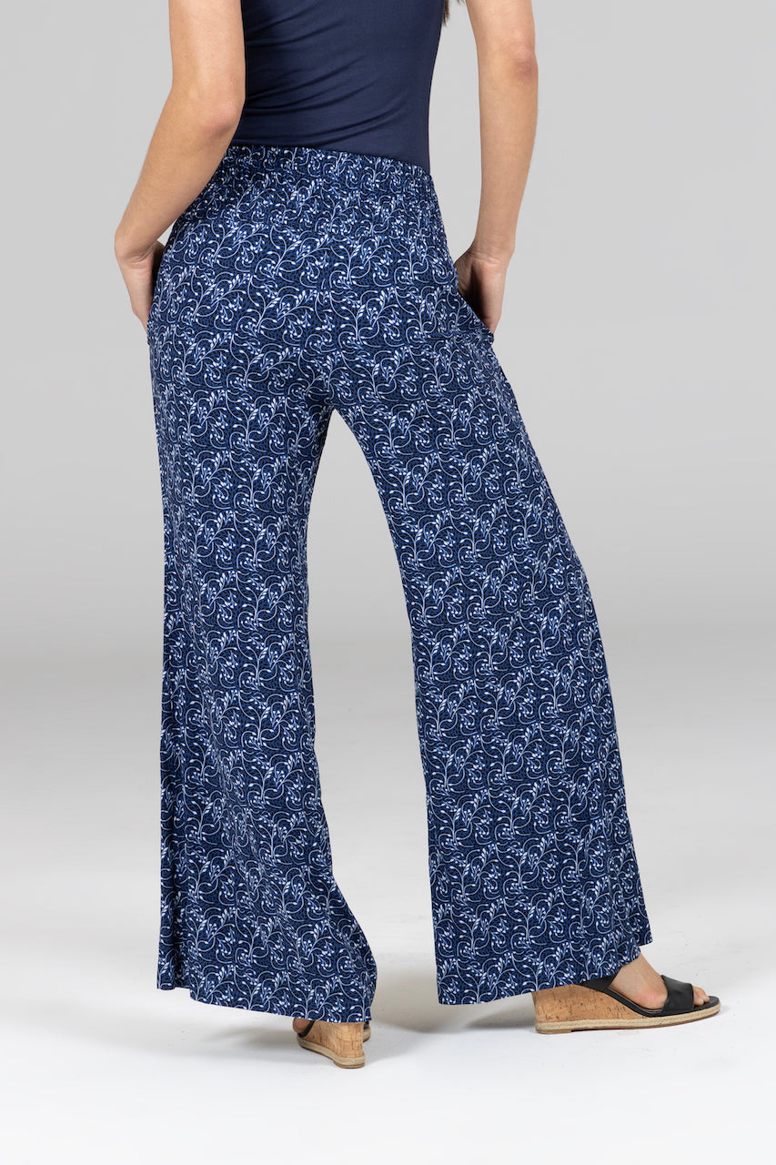 Back view of woman wearing high rise smocked waistband with wide leg opening