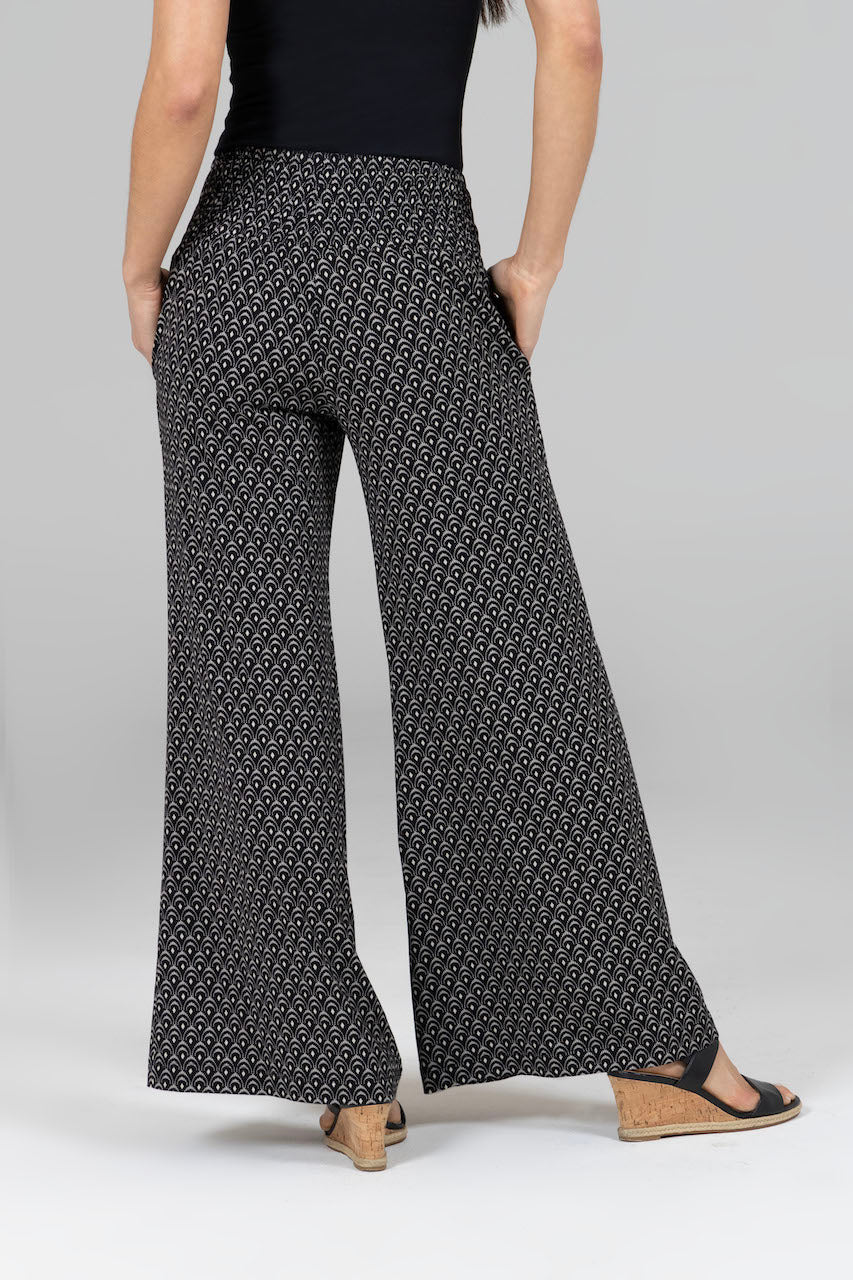 Back view of the Portofino Travel Pant in woodblock print, showcasing the flattering fit and unique design from behind