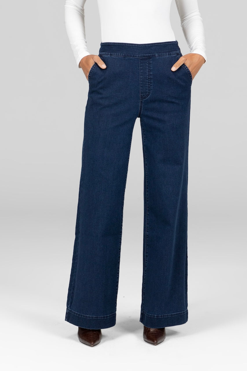 Woman wearing dark wash stretch denim trousers\