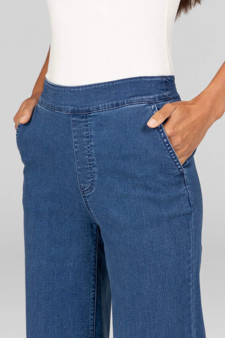 Close up view of woman wearing classic wash stretch denim trousers with pockets