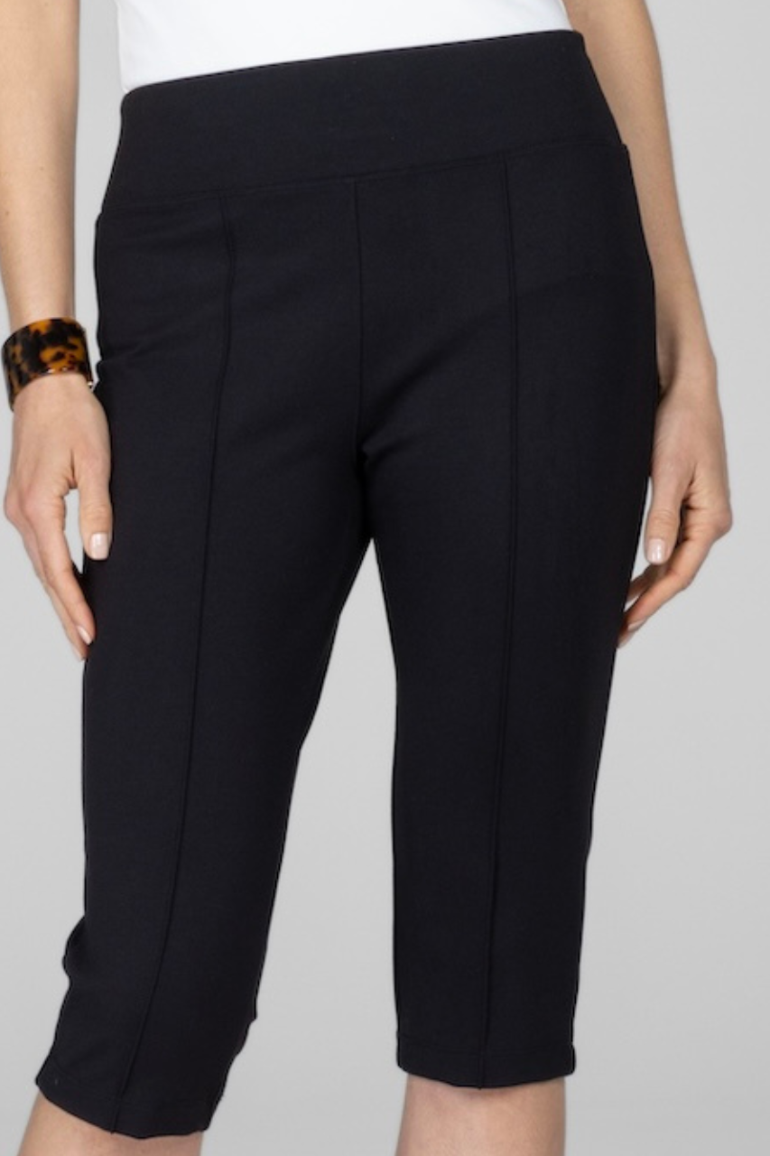 Close up view of woman wearing knee length pants with front pintucks