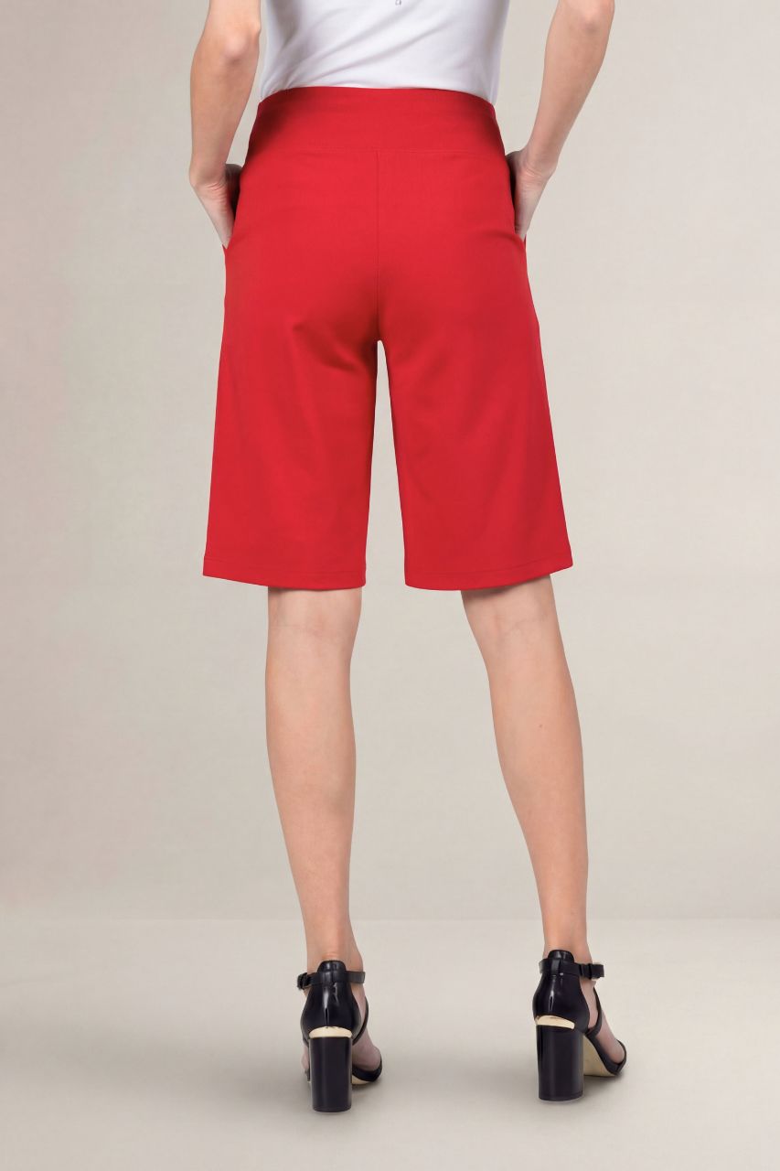 Person wearing red shorts on a plain background