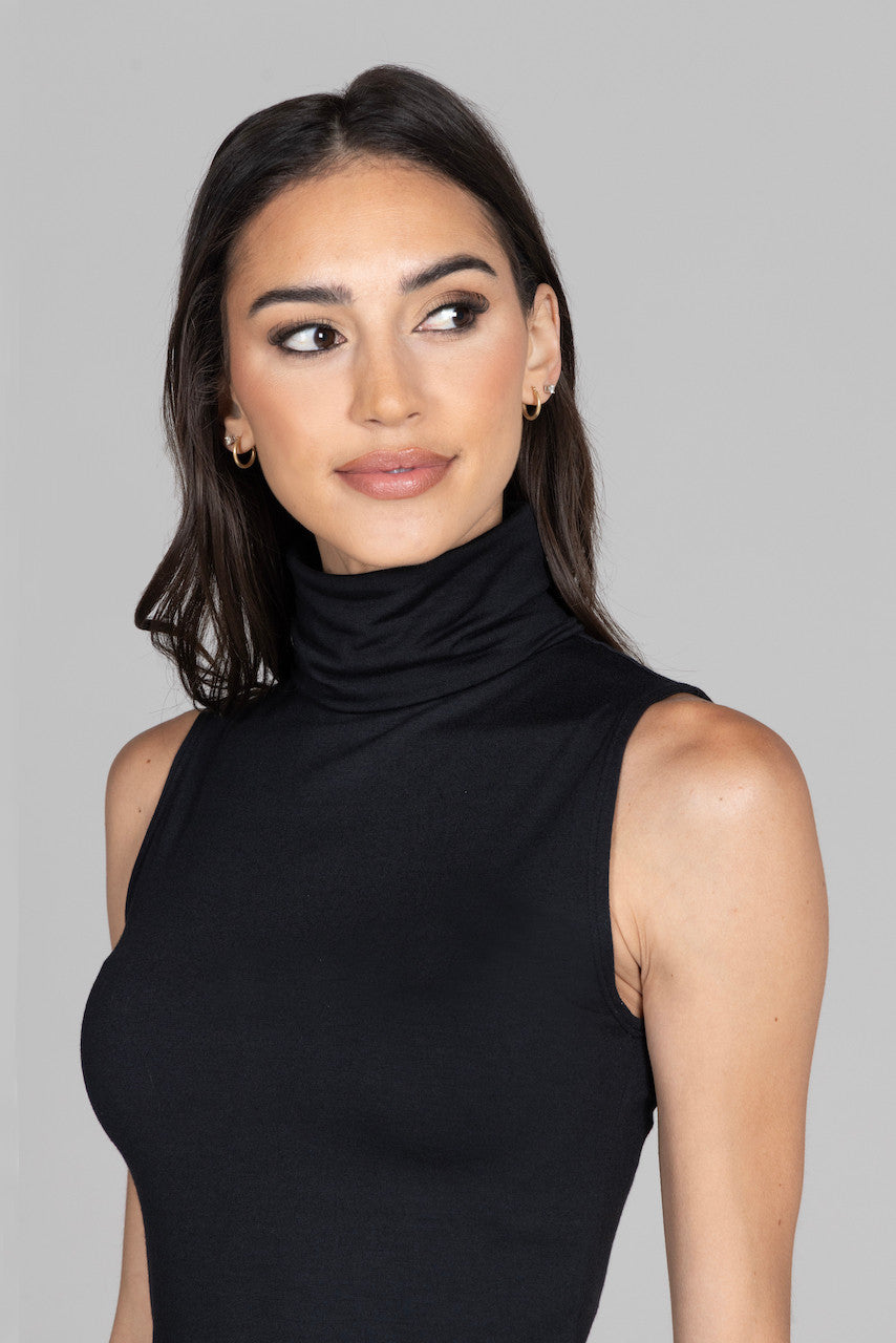 Close-up of the black sleeveless mock neck, showcasing the smooth fabric and elegant neckline detail for a refined look