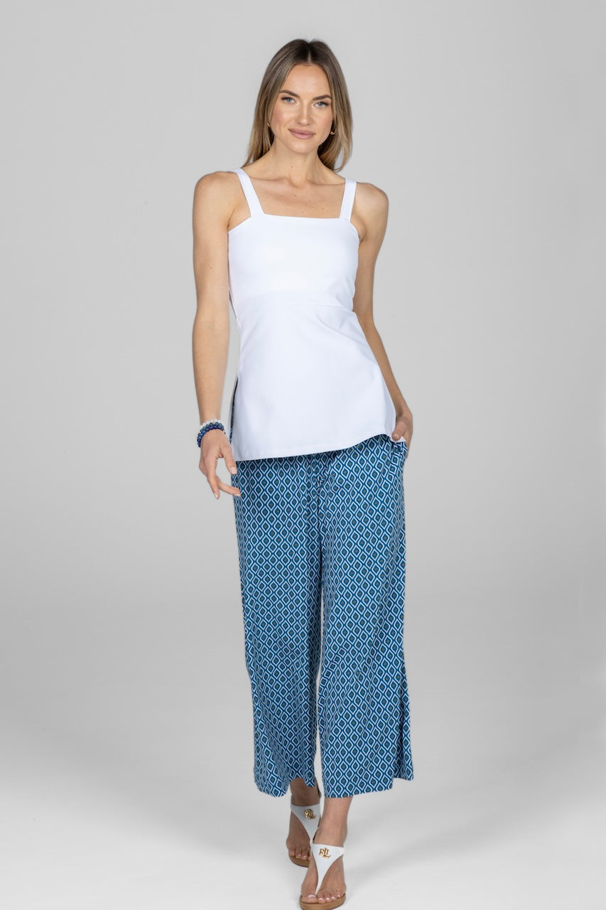 Woman wearing white cami with blue geometric printed ankle pants