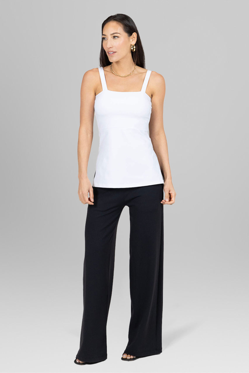 Front view of the Side Slit Cami in white paired with dress pants, showcasing a sophisticated and polished look ideal for professional or formal settings