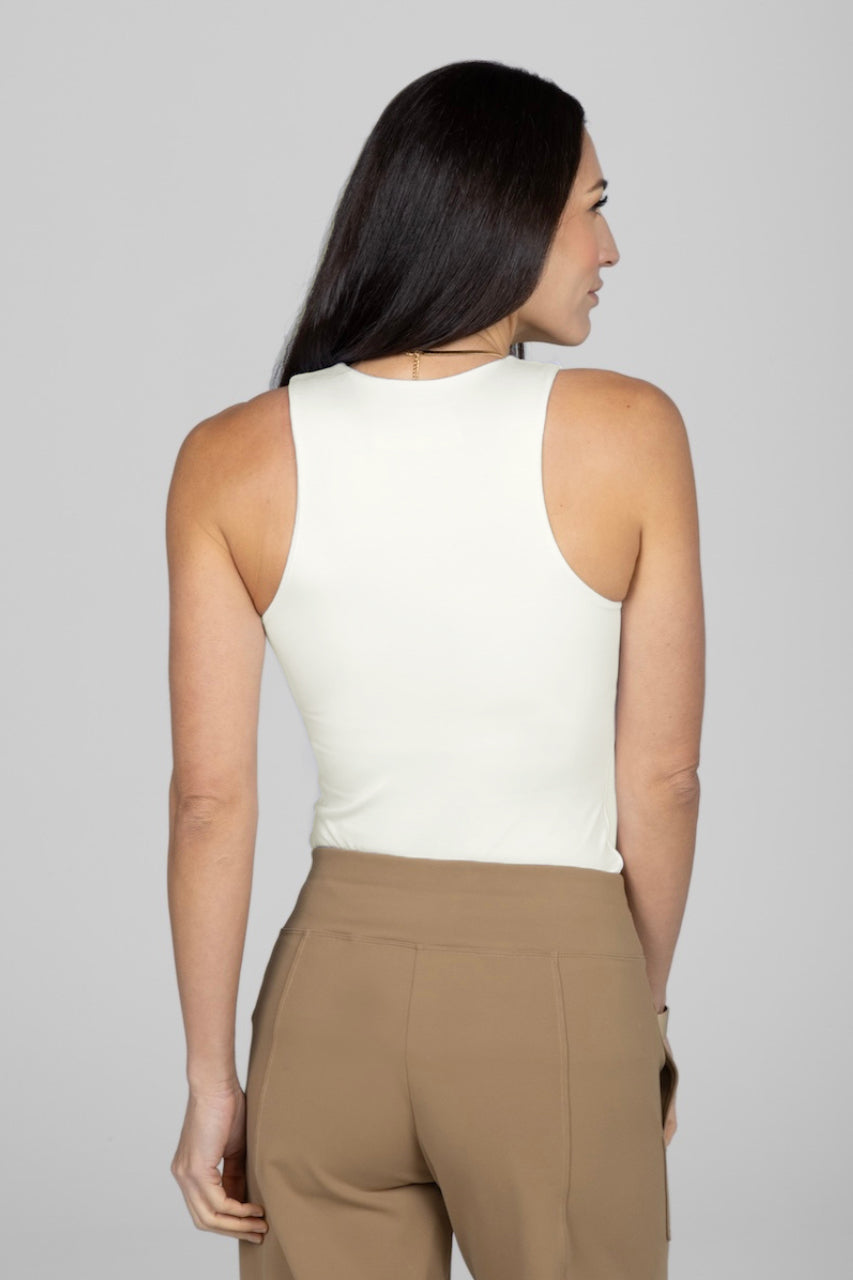Back view of woman wearing ivory tank top
