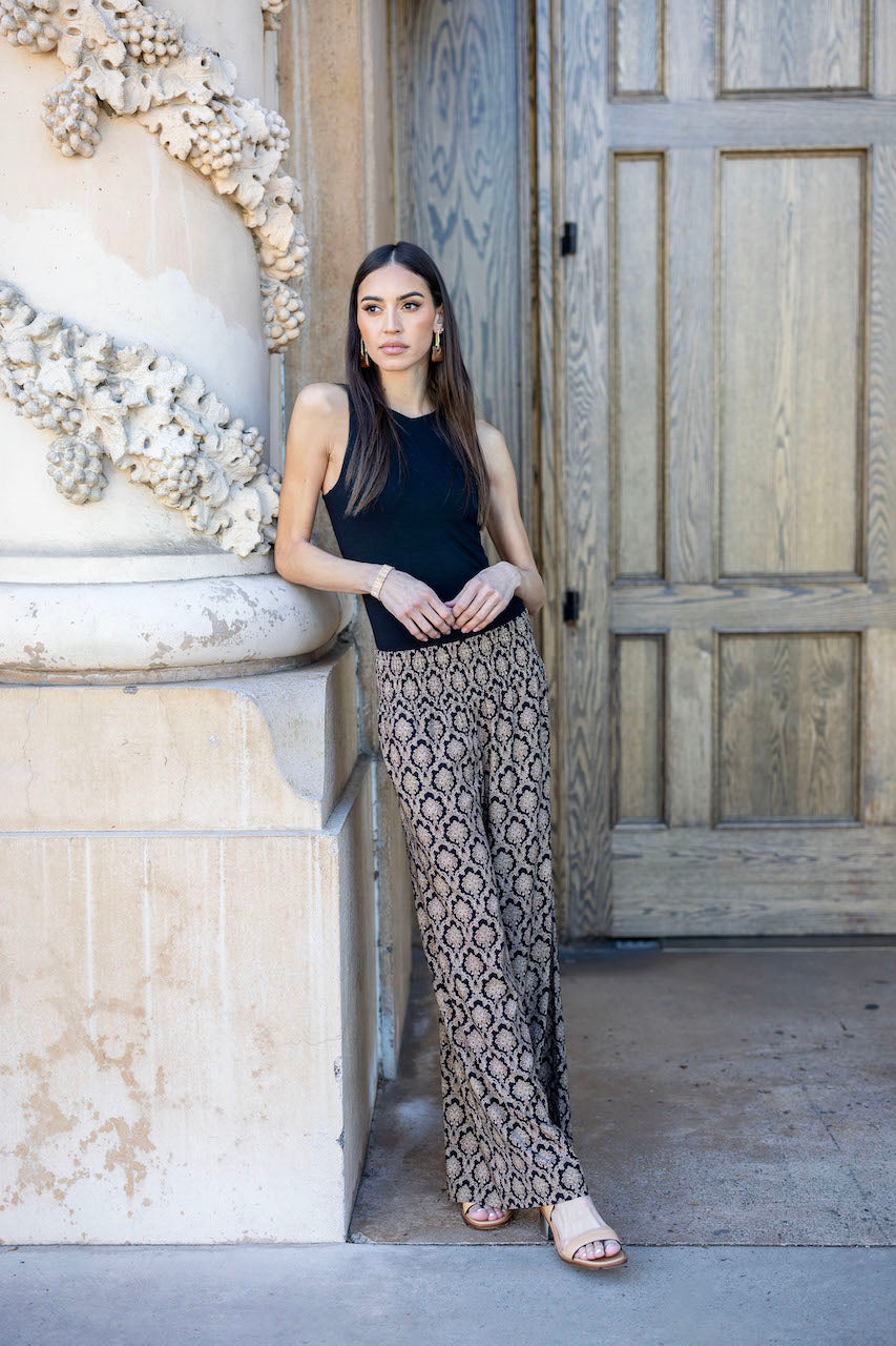 Model wearing the Travel Tank in black paired with casual pants, showcasing a relaxed yet stylish outfit perfect for everyday wear.