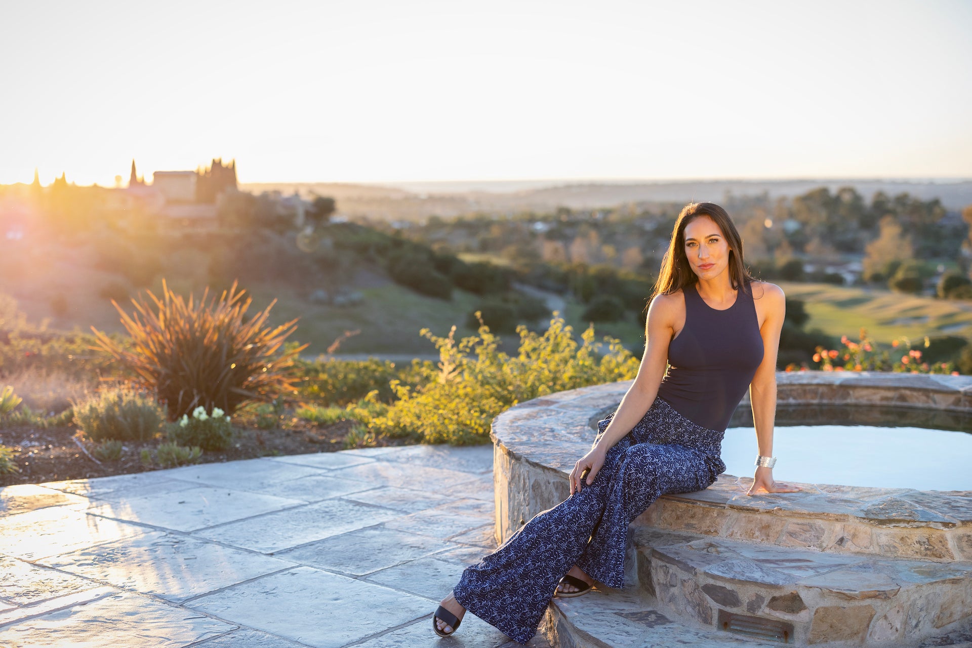 Model sitting in a side pose on sunset in TRAVEL TANK: MARINE NAVY