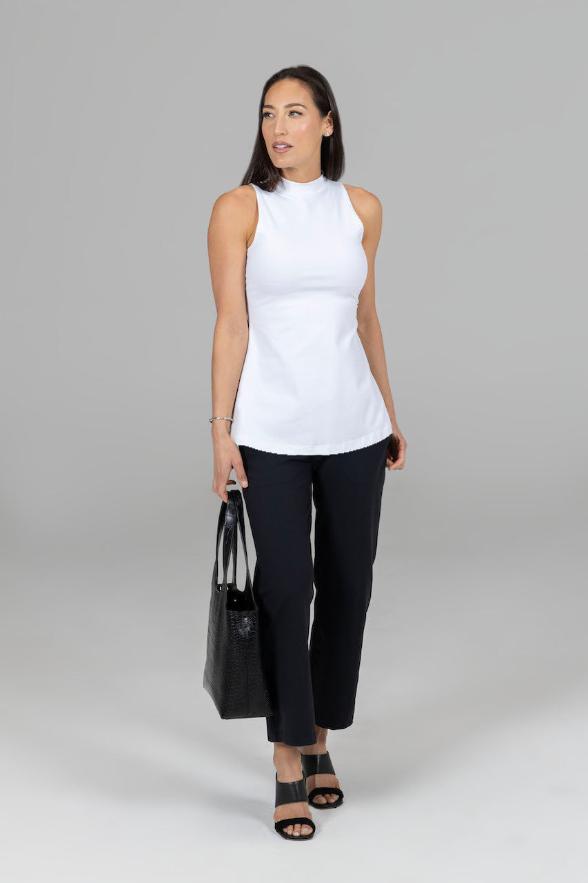 Woman wearing a white top paired with the High Waist Ankle Pant in black, showcasing a chic and timeless look perfect for any occasion