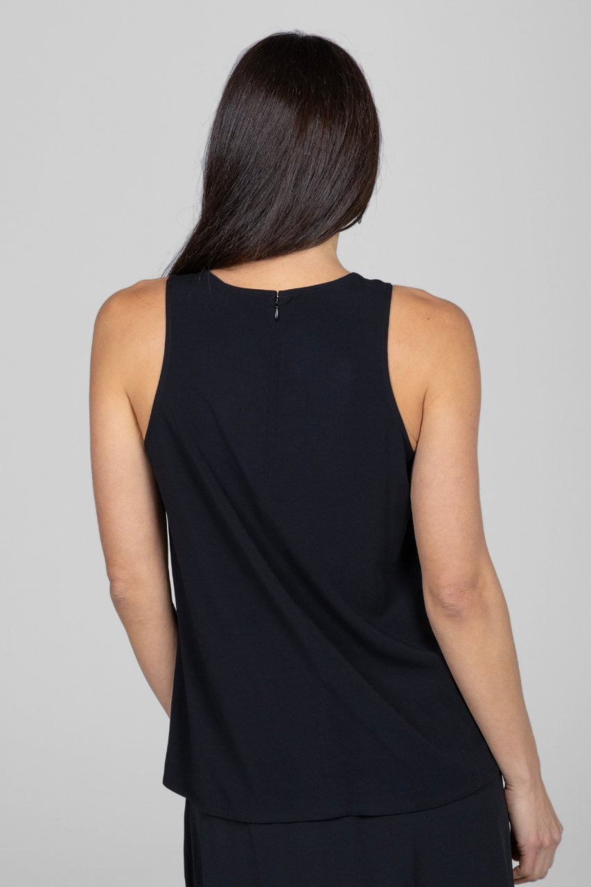 Back view of woman wearing sleeveless black top with hidden zipper